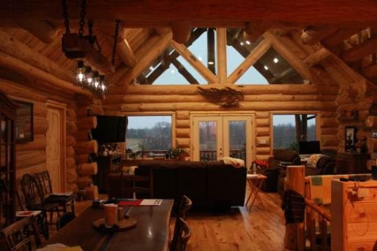 Great room log trusses above the dining area