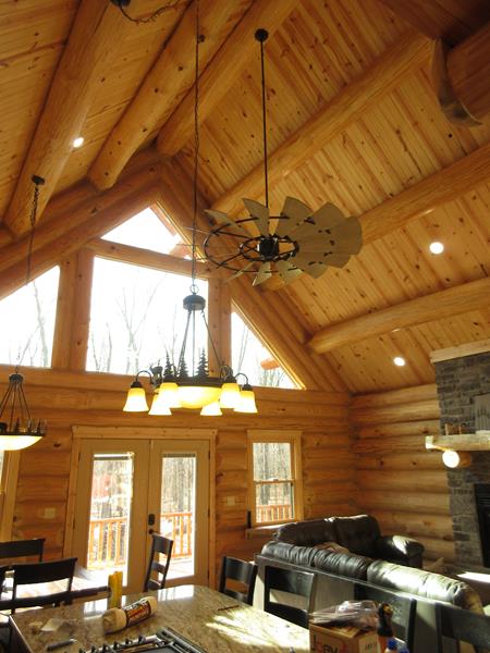 The Crystal great room under exposed log purlins