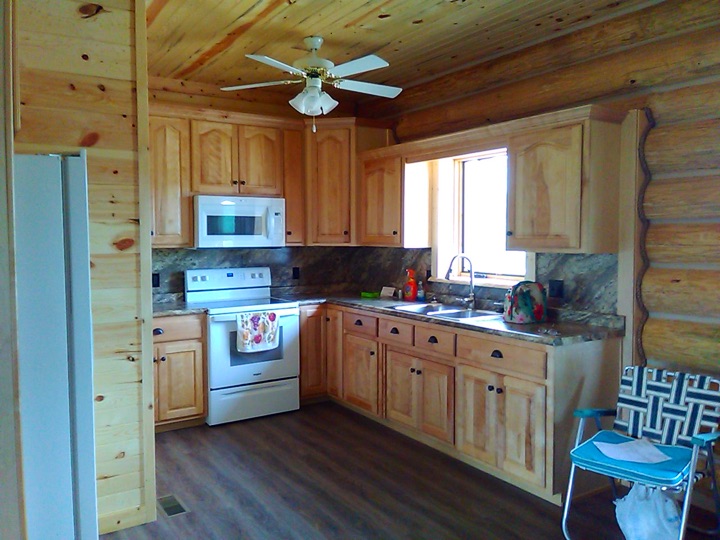 Kitchen with knotty cabinetry and a window over the sink