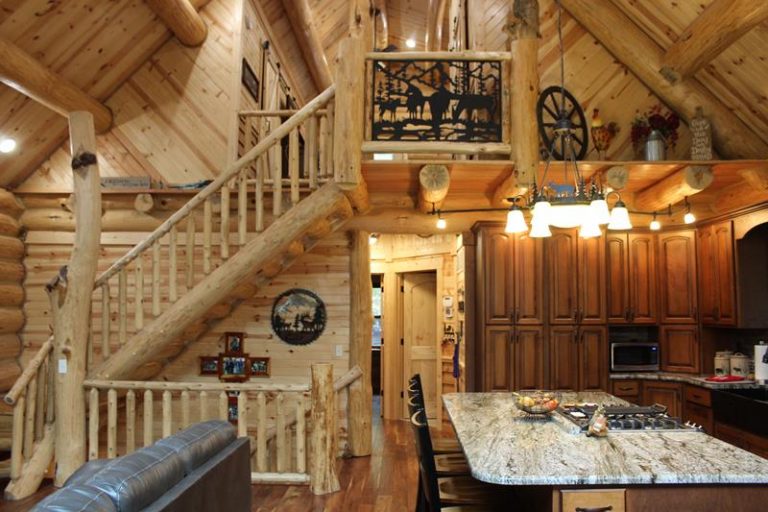 Log stair to the loft beside the kitchen island