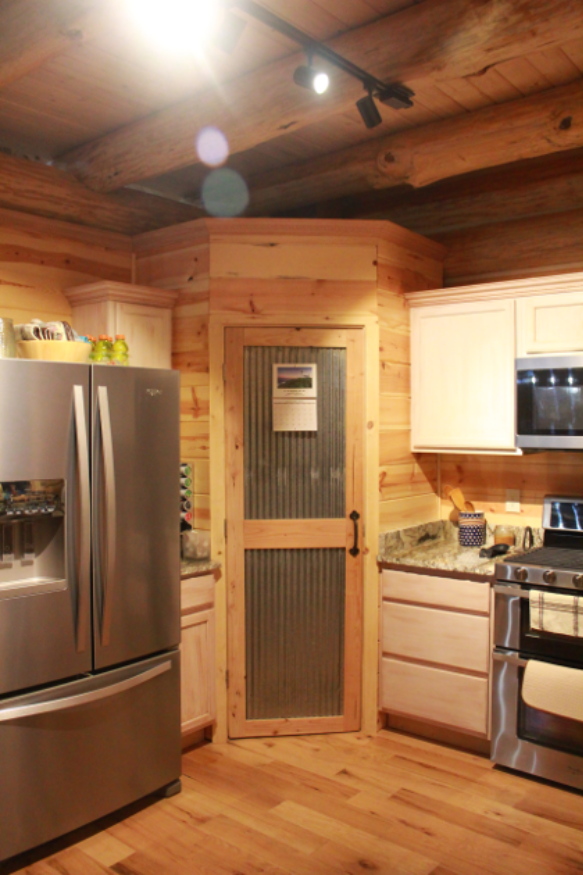 Gordon kitchen with stainless appliances and log walls