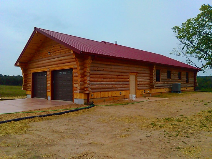 The Presnell with its attached garage under a red metal roof