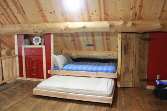 Bedroom with log walls and painted built-ins