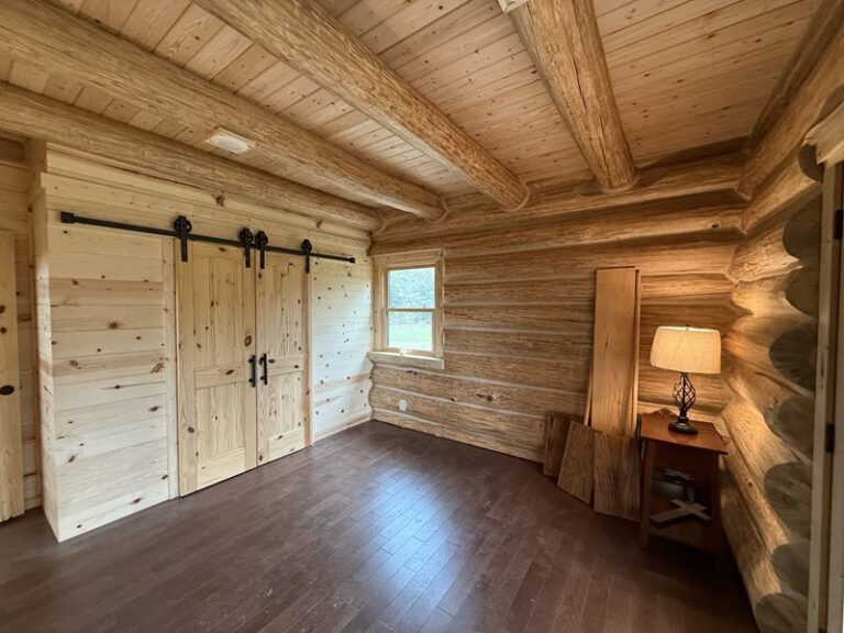 Barn-door detail and log corner in the main room