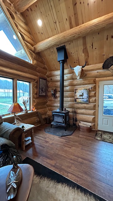Wood stove hearth set against a full-scribe log wall