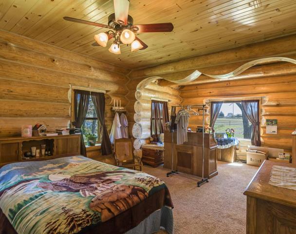 Upstairs bedroom with log accents and porch access